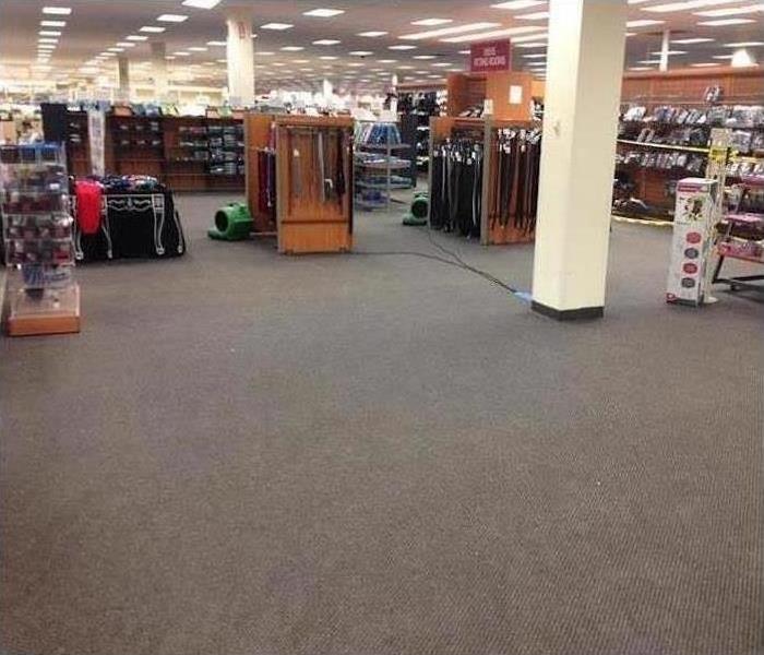 SERVPRO air movers drying water soaked carpet in a retail store in Orlando, FL 