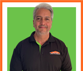 Javier, SERVPRO employee, cut out and set against a green backdrop