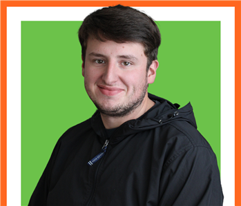 Tristen in front of a green background, SERVPRO Employee, Male