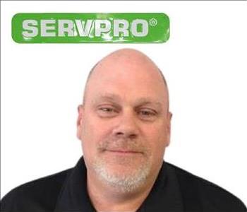Kevin, SERVPRO employee male, in front of white background and green servpro sign