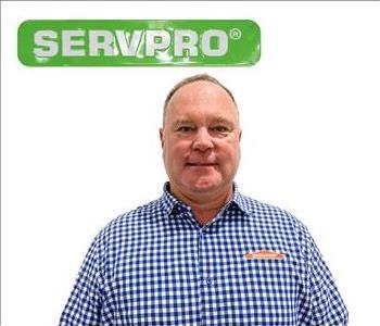 Jeff Truitt, male servpro employee wearing blue and plaid shirt in front of white background