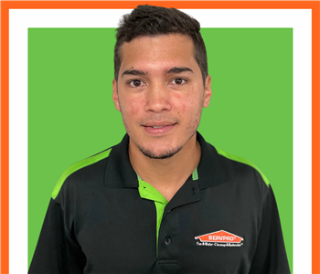 SERVPRO employee against a white background and green SERVPRO logo